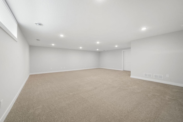 10142 Arrowwood Trl, Woodbury, MN 55129 - below grade area featuring light colored carpet, baseboards, and recessed lighting