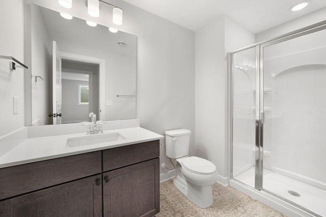10142 Arrowwood Trl, Woodbury, MN 55129 - bathroom featuring a stall shower, toilet, vanity, and baseboards