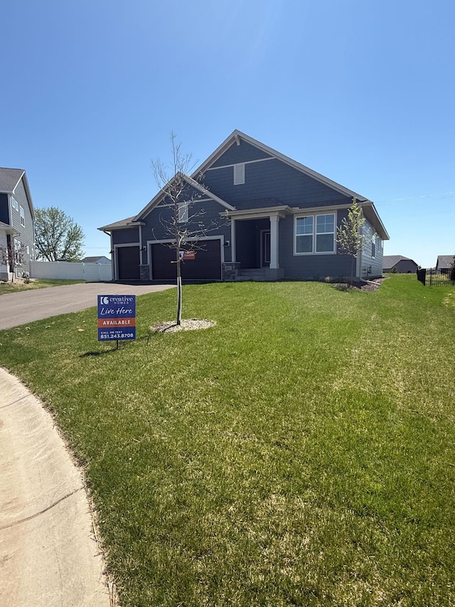 10142 Arrowwood Trl, Woodbury, MN 55129 - view of front of house with driveway, a garage, and a front lawn