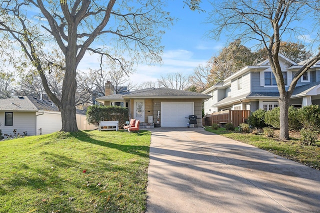 view of front of home featuring a garage and a front yard