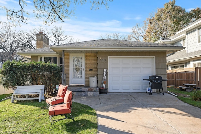 view of front of property with a garage and a front lawn