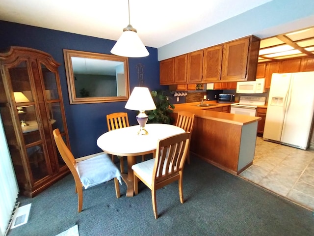 dining space with visible vents and light carpet