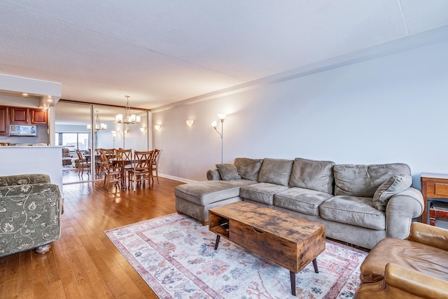 living room featuring light hardwood / wood-style floors and a chandelier