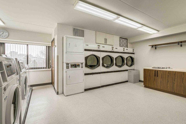 laundry area with stacked washer and dryer and independent washer and dryer