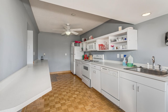 kitchen featuring white appliances, light parquet floors, ceiling fan, sink, and white cabinets