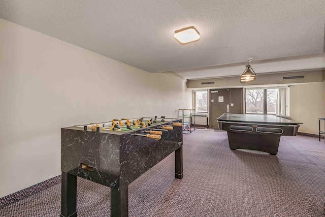 playroom featuring carpet and a textured ceiling