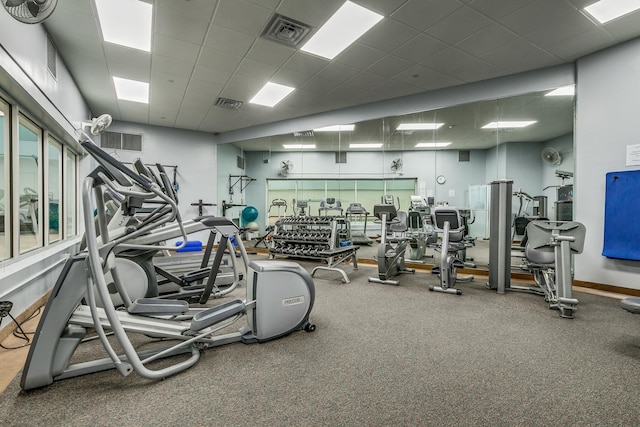 exercise room with a paneled ceiling