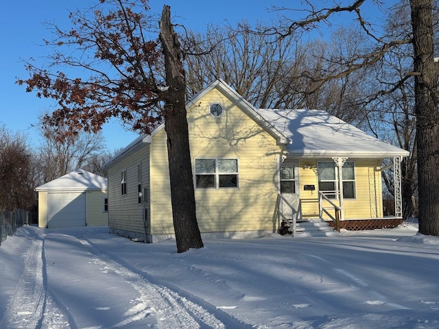 view of front facade featuring a garage and an outbuilding