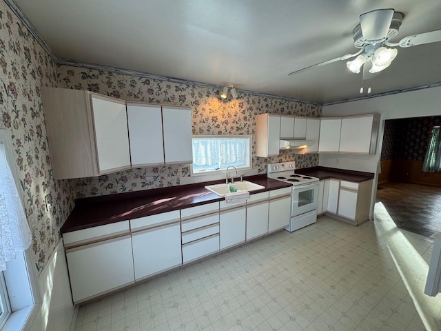 kitchen featuring white cabinetry, ceiling fan, white electric range, and sink