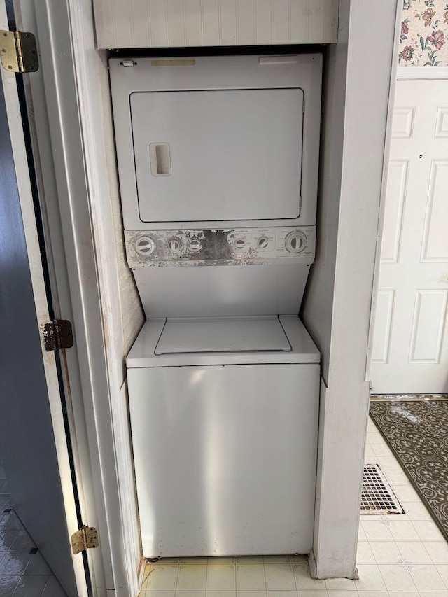 laundry area with stacked washer and clothes dryer