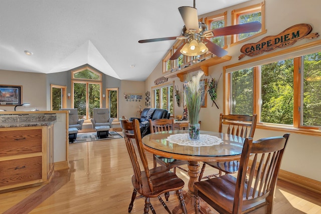 dining room featuring light hardwood / wood-style flooring, ceiling fan, and lofted ceiling