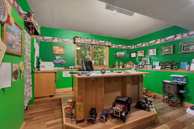 interior space featuring hardwood / wood-style flooring and a textured ceiling