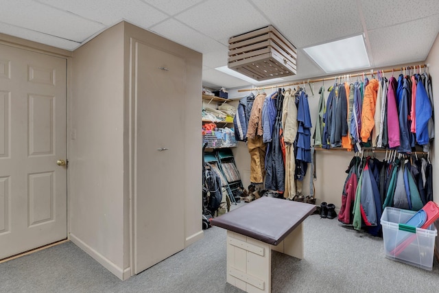 walk in closet with light carpet and a drop ceiling