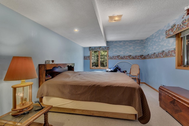 bedroom with light carpet and a textured ceiling