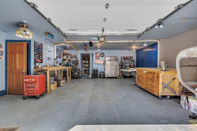 garage featuring a workshop area and a garage door opener