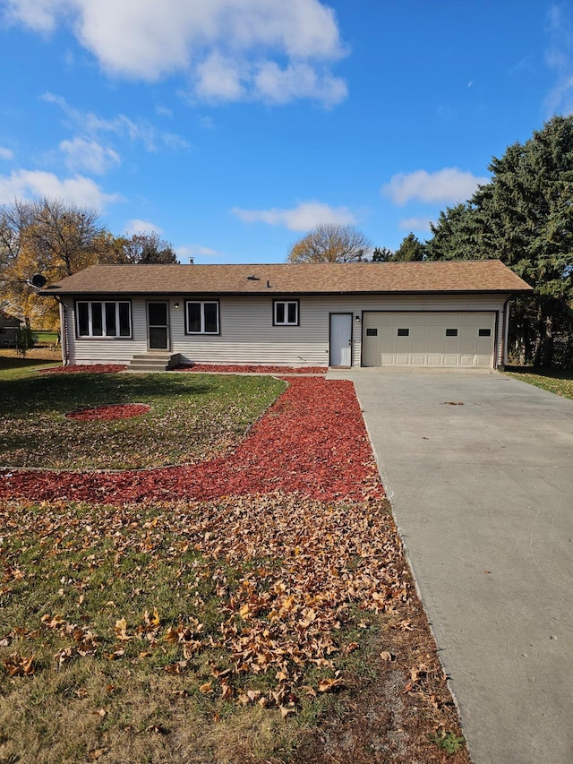 ranch-style house with a garage and a front yard