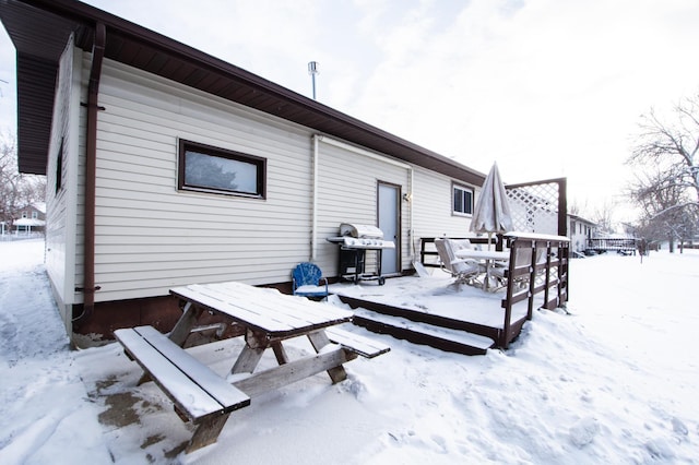 view of snow covered back of property