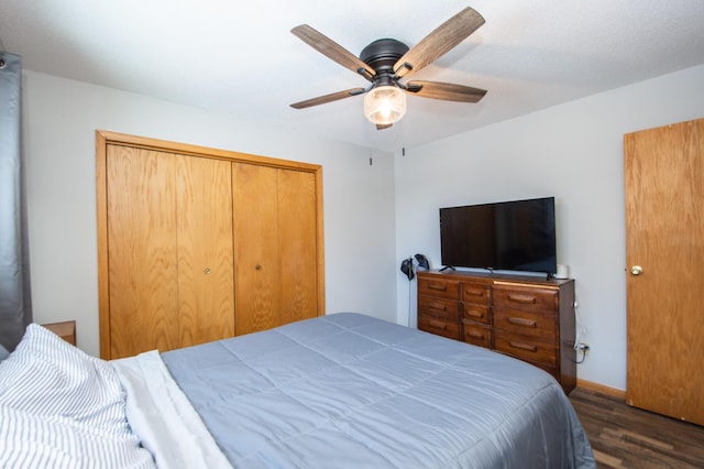 bedroom featuring ceiling fan, dark hardwood / wood-style floors, and a closet