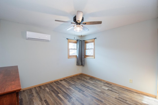 spare room with hardwood / wood-style floors, an AC wall unit, and ceiling fan