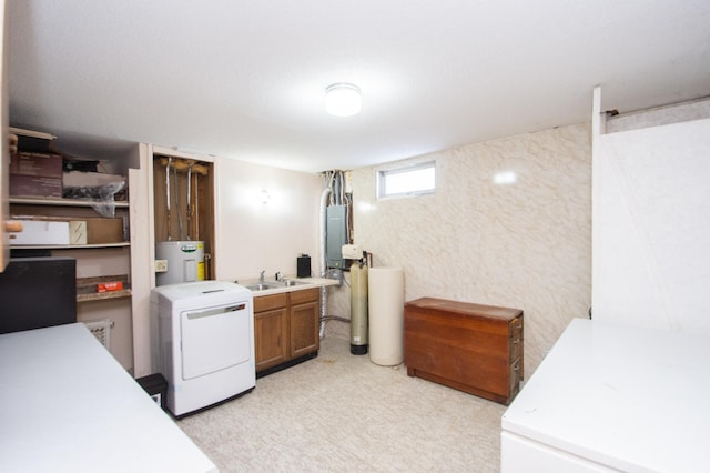 clothes washing area with cabinets, washer / dryer, electric water heater, and sink