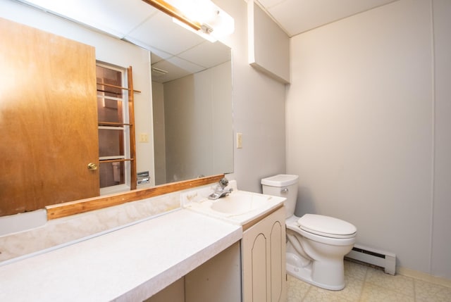 bathroom featuring vanity, toilet, and a baseboard heating unit