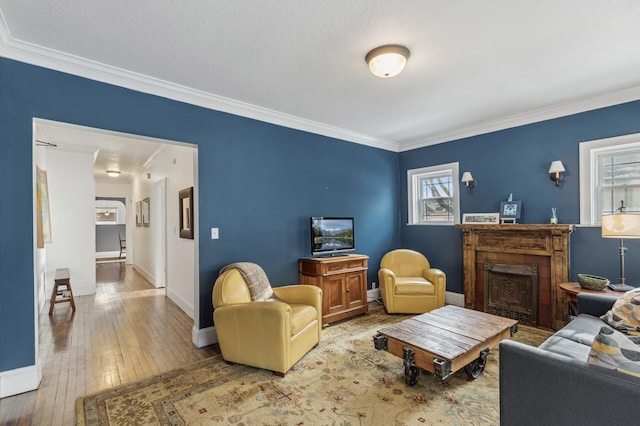 living room with hardwood / wood-style flooring and crown molding