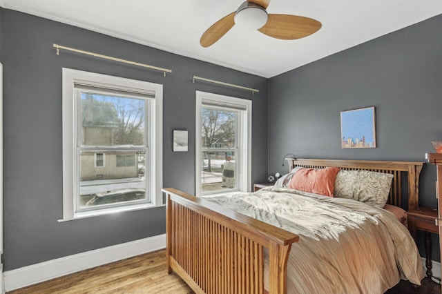 bedroom with ceiling fan and light hardwood / wood-style floors