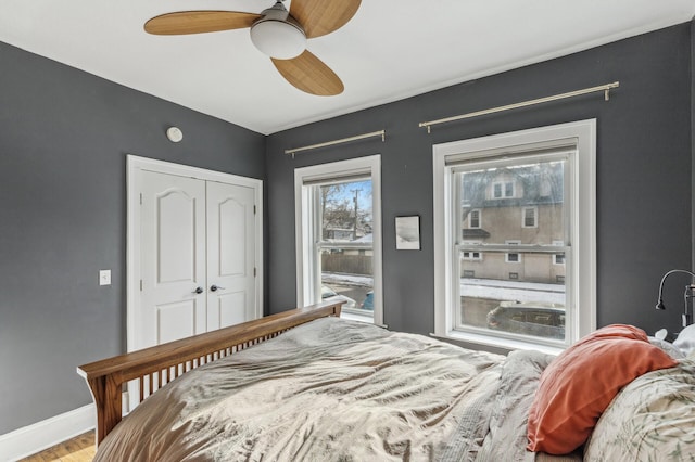 bedroom with hardwood / wood-style flooring, ceiling fan, and a closet