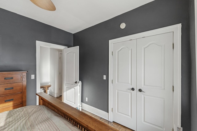 bedroom featuring ceiling fan and a closet