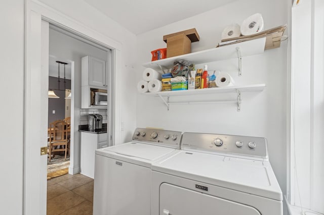 washroom with tile patterned floors, laundry area, and separate washer and dryer