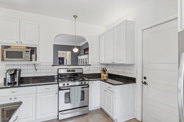 kitchen featuring white cabinets, stainless steel appliances, and backsplash