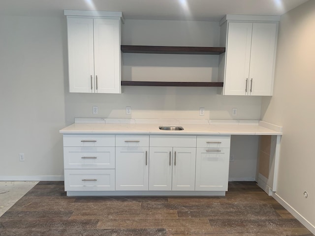 kitchen with dark wood-type flooring, sink, and white cabinets