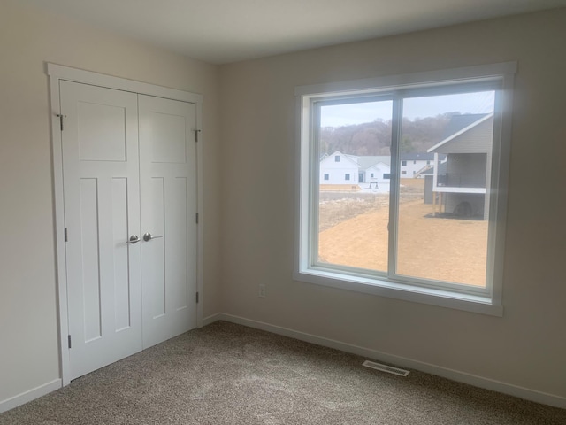 unfurnished bedroom featuring a closet and carpet