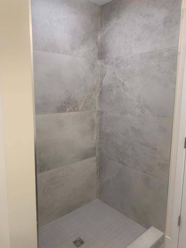 bathroom with a tile shower