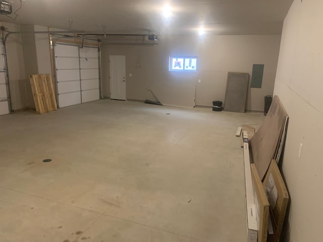 garage with a garage door opener and electric panel