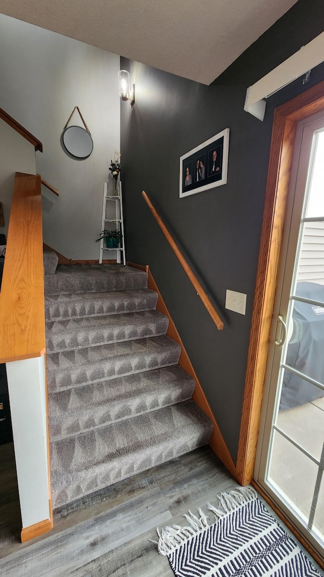 stairs featuring hardwood / wood-style floors