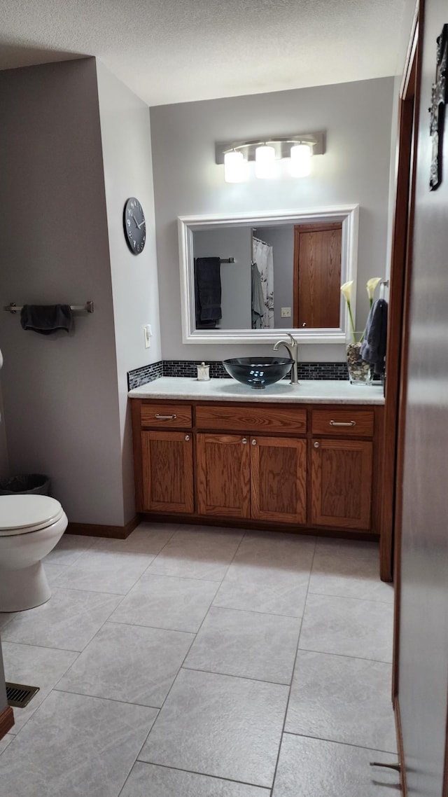 bathroom with tile patterned floors, vanity, and toilet