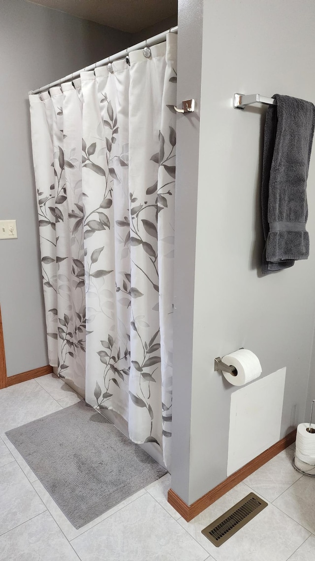 bathroom with tile patterned floors