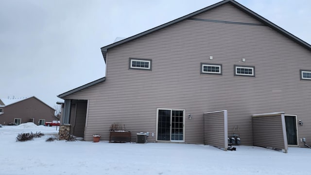 view of snow covered back of property