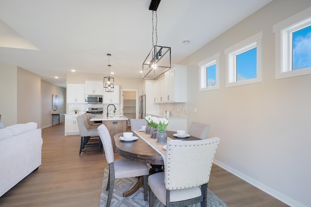 dining area with hardwood / wood-style floors and sink