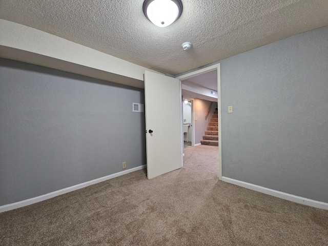 basement with a textured ceiling and carpet floors