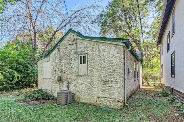 view of side of property with central air condition unit