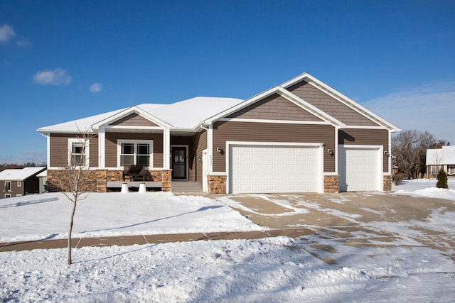 craftsman inspired home featuring stone siding and an attached garage