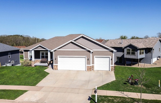 craftsman house featuring concrete driveway, an attached garage, a front lawn, and stone siding