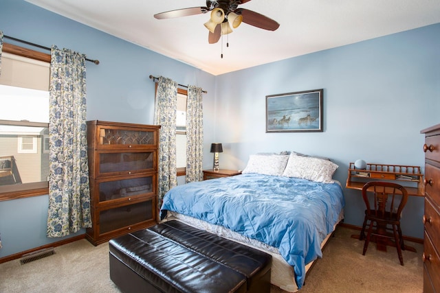 carpeted bedroom with ceiling fan, baseboards, and visible vents