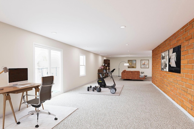 exercise room featuring brick wall, carpet flooring, baseboards, and recessed lighting