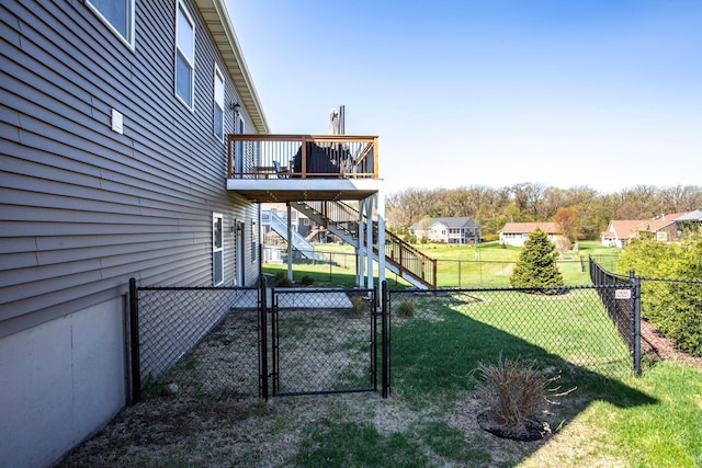 view of yard featuring stairs, a deck, a fenced backyard, and a gate