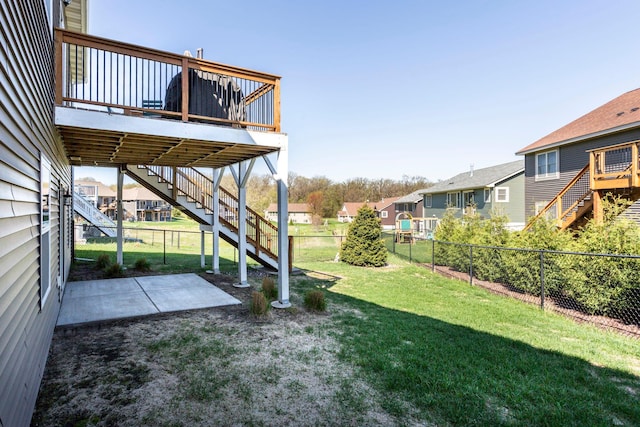 view of yard featuring a patio, a residential view, a deck, stairway, and a fenced backyard