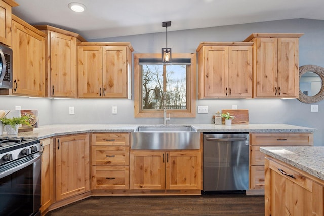 kitchen with appliances with stainless steel finishes, lofted ceiling, a sink, and light brown cabinetry