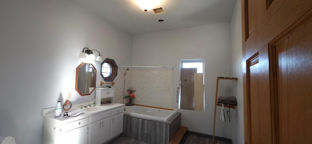 bathroom with vanity and a tub